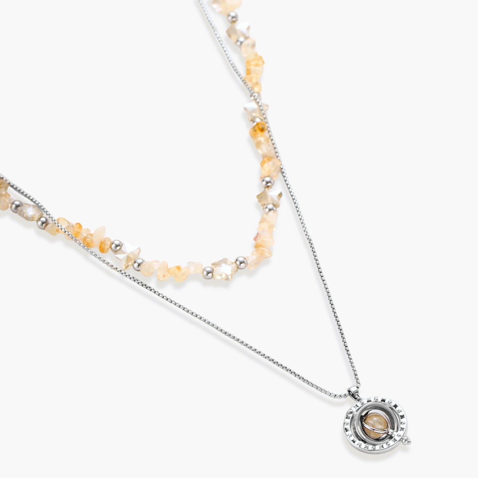 Two-layer necklace with natural stone chips and eco-brass beads, featuring a circular wrapped pendant on cream background.
