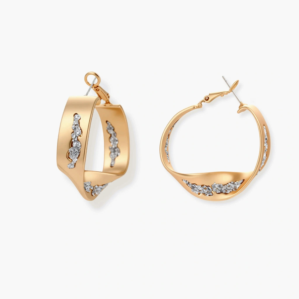 Gold circular pendant necklace with crystals on black cord paired with matching geometric hoop earrings on white background.