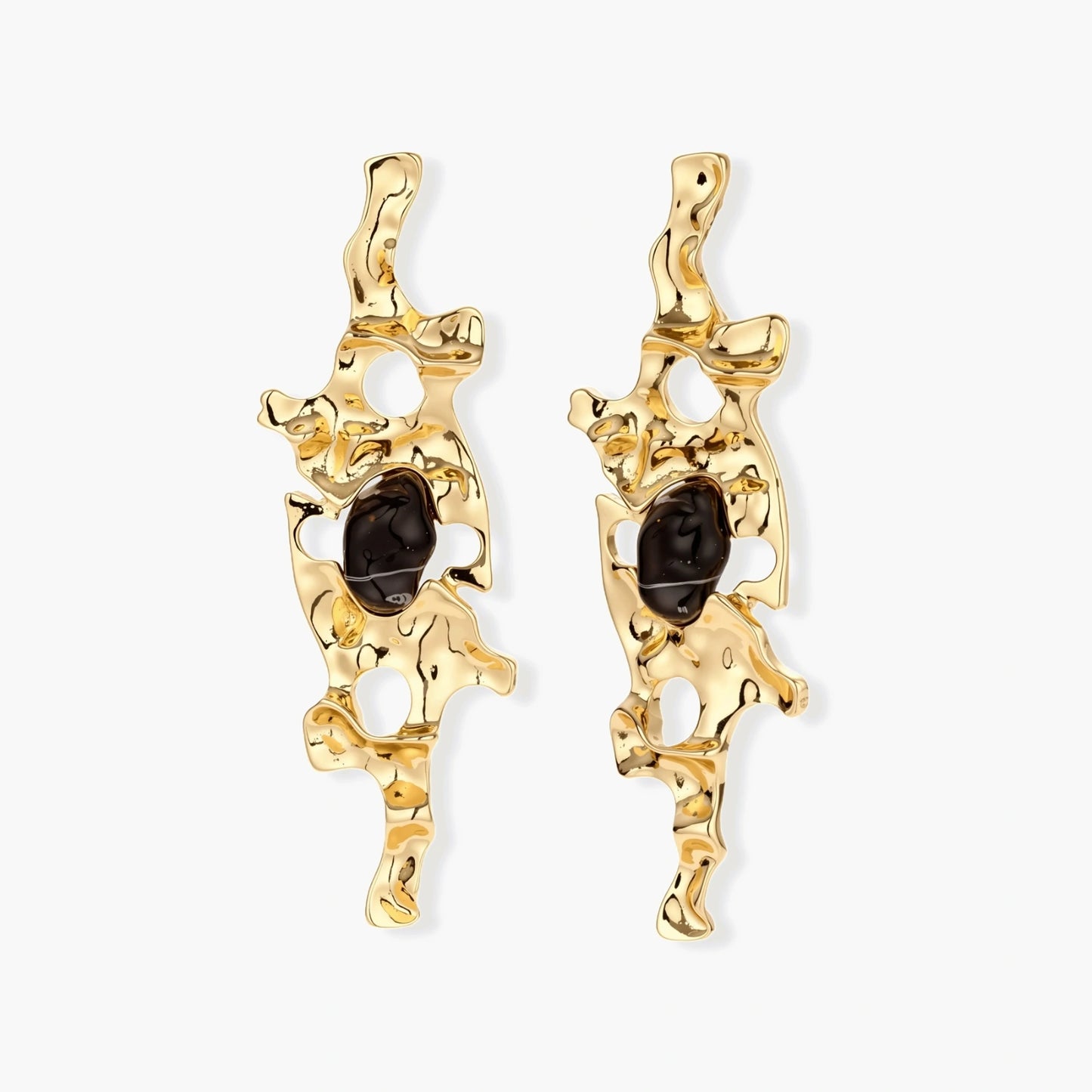 Elongated sculptural earrings with organic openwork design in eco-zinc alloy and dark resin accents on white background.