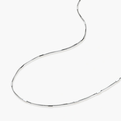 Delicate platinum-plated sterling silver necklace with alternating textured cubic links and smooth chain sections.
